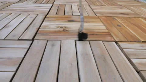 Applying Protective Oil to Wooden Deck with a Brush Stock Footage 284672801