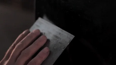 Applying putty to a car panel Stock Footage 129023439