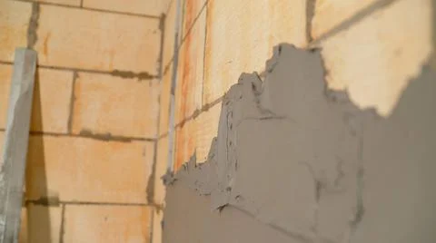 Applying the putty solution to the wall. Close-up of the spatula for applying Stock Photos