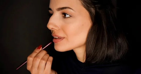 Applying red lipstick Stock Footage 124551953