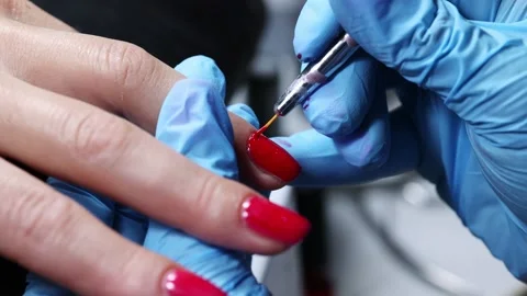Applying Red Nail Polish in Beauty Salon Stock Footage 313229145