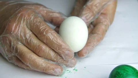 Applying a red paint on an egg Stock Footage 88260419