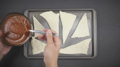Applying Red Sauce to Dough Stock Footage 61325025