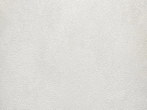 Applying rough white plaster texture on wall surface background Stock Photos