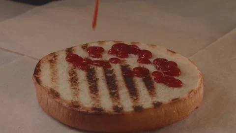 Applying sauce to a burger bun. Stock Footage 312789636