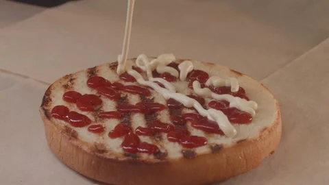 Applying sauce to a burger bun. Stock Footage 312789673
