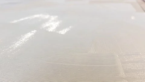 Applying a smooth layer of texture material to a surface in an indoor setting du Stock Footage 326696857