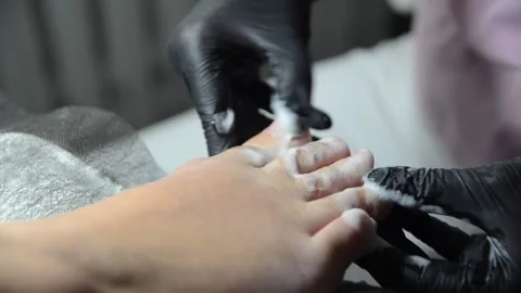 Applying special foam to toenails during professional pedicure Stock Footage 344039547