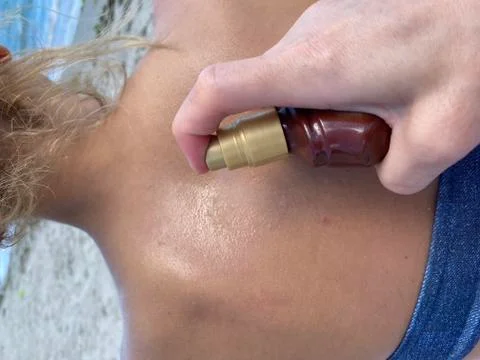 Applying sunscreen on the beach, close up Stock Photos