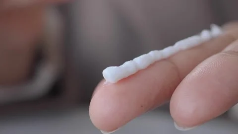 Applying sunscreen cream to the hand in a close-up shot Stock Footage 343230567