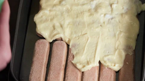 Applying sweet cream to the surface of the cookie while making the tiramisu.. Stock Footage 228429359