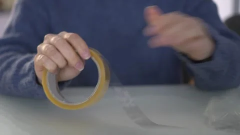 Applying Tape for Various Uses and Creative Crafts in Everyday Life and Stock Footage 318543642