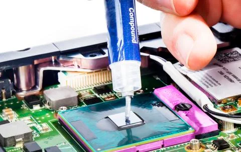 Applying thermal compound on video chip with syringe close view Stock Photos