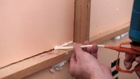 Applying thermal insulation foam with a gun Stock Footage 333392700