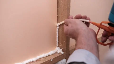 Applying thermal insulation foam with a gun Stock Footage 334027802