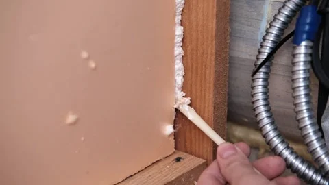 Applying thermal insulation foam with a gun Stock Footage 335446679