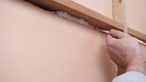 Applying thermal insulation foam with a gun Stock Footage 336064484