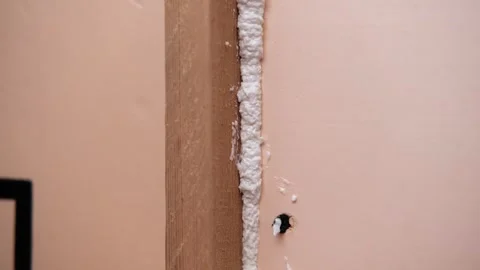 Applying thermal insulation foam with a gun Stock Footage 336064667