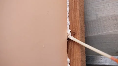 Applying thermal insulation foam with a gun Stock Footage 336064975