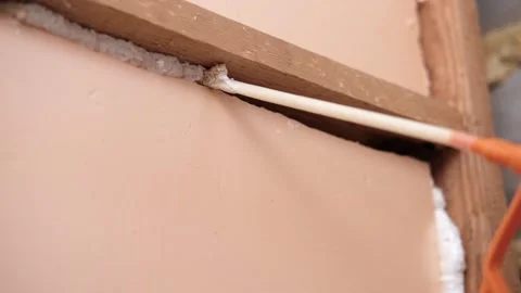 Applying thermal insulation foam with a gun Stock Footage 336729485