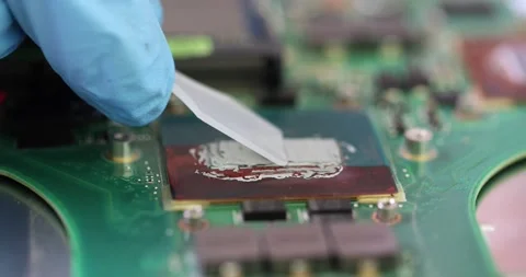 Applying thermal paste to computer central processing unit and repairing Stock Footage 237315663