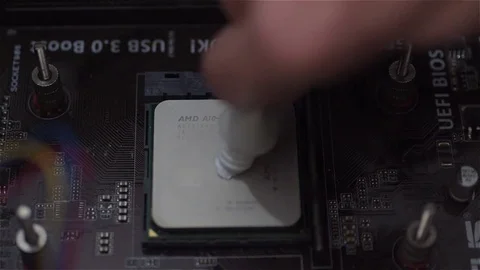 Applying thermal paste on a computer micro processor Video stock 78989249