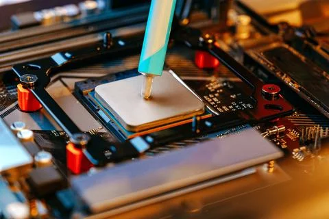 Applying thermal paste to a computer processor 写真素材