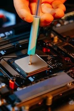 Applying thermal paste to a computer processor 写真素材