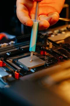 Applying thermal paste to a computer processor 写真素材