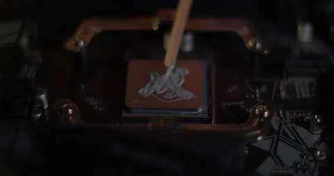 Applying Thermal Paste to CPU Processor for Computer Cooling Stock Footage 331748335