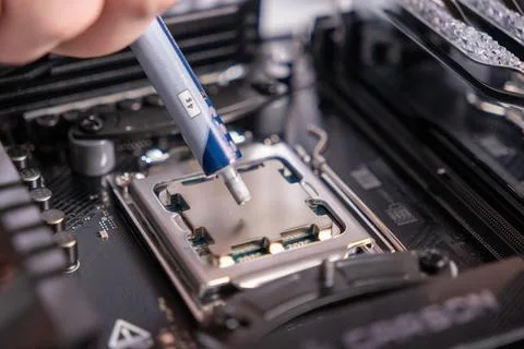 Applying thermal paste on processor, CPU installation, computer maintenance,  写真素材