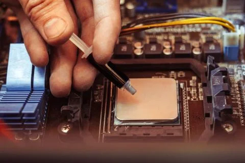 Applying thermal paste on the processor Stock Photos