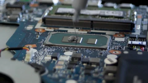 Applying thermal paste to the silicon crystal of the processor. A syringe Stock Footage 297071275