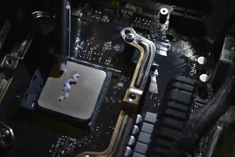 Applying thermal paste to the surface of the computer processor. Thermal in.. Stock Photos