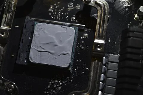 Applying thermal paste to the surface of the computer processor. Thermal in.. Stock Photos