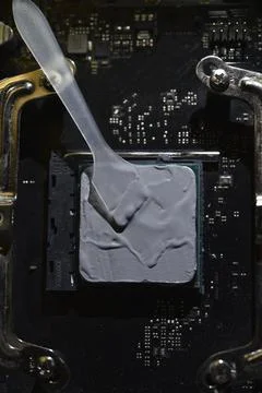 Applying thermal paste to the surface of the computer processor. Thermal in.. Stock Photos