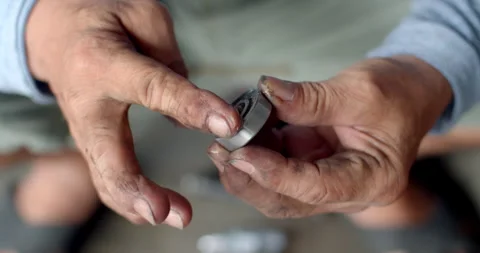 Applying thick grease to a new ball bearing before inserting it into the hub. Stock Footage 311664820