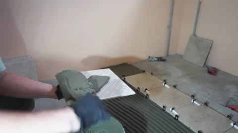 Applying thinset mortar on a tile. Apply the adhesive, closeup. Stock-Footage 150962904