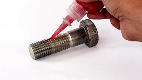 Applying threadlocker to a large bolt. Stock Footage 342409965