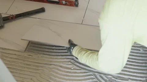 Applying the Tiles on the floor Stock Footage 284408331