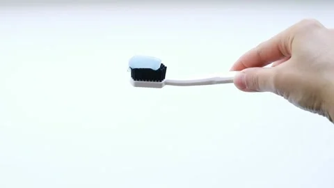 Applying toothpaste to a toothbrush. Dental care concept. Close-up. Video stock 244941103