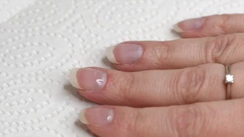 Applying transparent base coat soak-off gel nail polish on natural nails Stock Footage 122128917