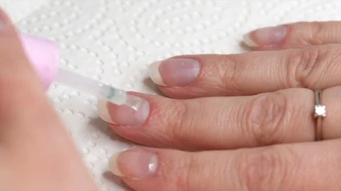 Applying transparent base coat soak-off gel nail polish on natural nails Video stock 122128932