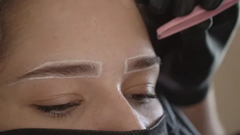 Applying Treatment to Eyebrows with Small Brush Stockbeeldmateriaal 345909495
