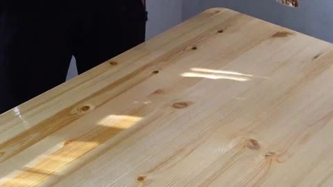Applying varnish to a wooden table with a brush, step-by-step close-up Stock Footage 330119841