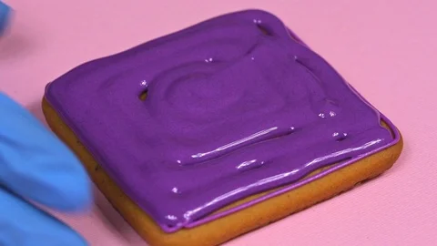 Applying violet glaze to ginger biscuits, close-up Stock Footage 126213279