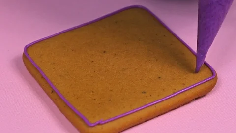Applying violet glaze to ginger biscuits, close-up Stock Footage 126213368