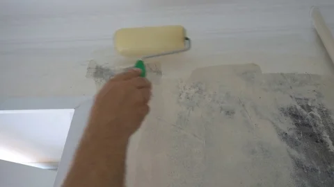 Applying Wallpaper paste to the wall with a roller,preparation for wallpapering Stock Footage 79594137