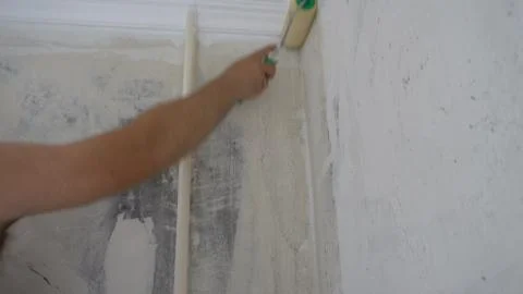 Applying Wallpaper paste to the wall with a roller,preparation for wallpaperi Stock Photos