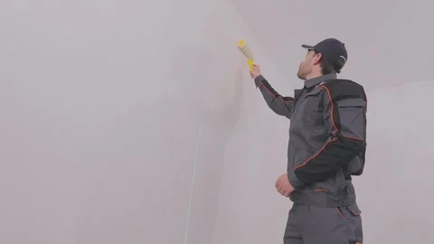Applying wallpaper paste to the wall surface in the room. Apply wallpaper paste Stock Footage 333122793